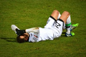 Injury football player laying down